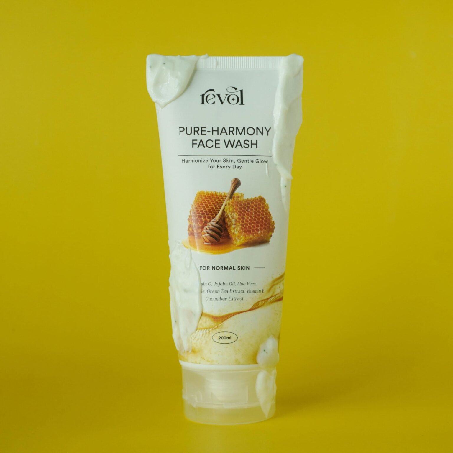 Revol Pure-Harmony Face Wash tube with honey on a yellow background for combination and normal skin