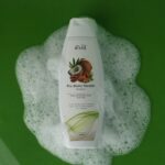 Revol Pro-Biotic Keratin Shampoo bottle with foam on a green background – best shampoo for hair fall in Pakistan.