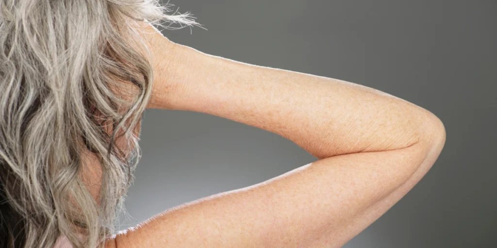 Close-up of a woman’s grey hair highlighting hair whitening reasons.