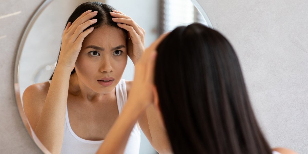 a woman looking at her reflection in a mirror