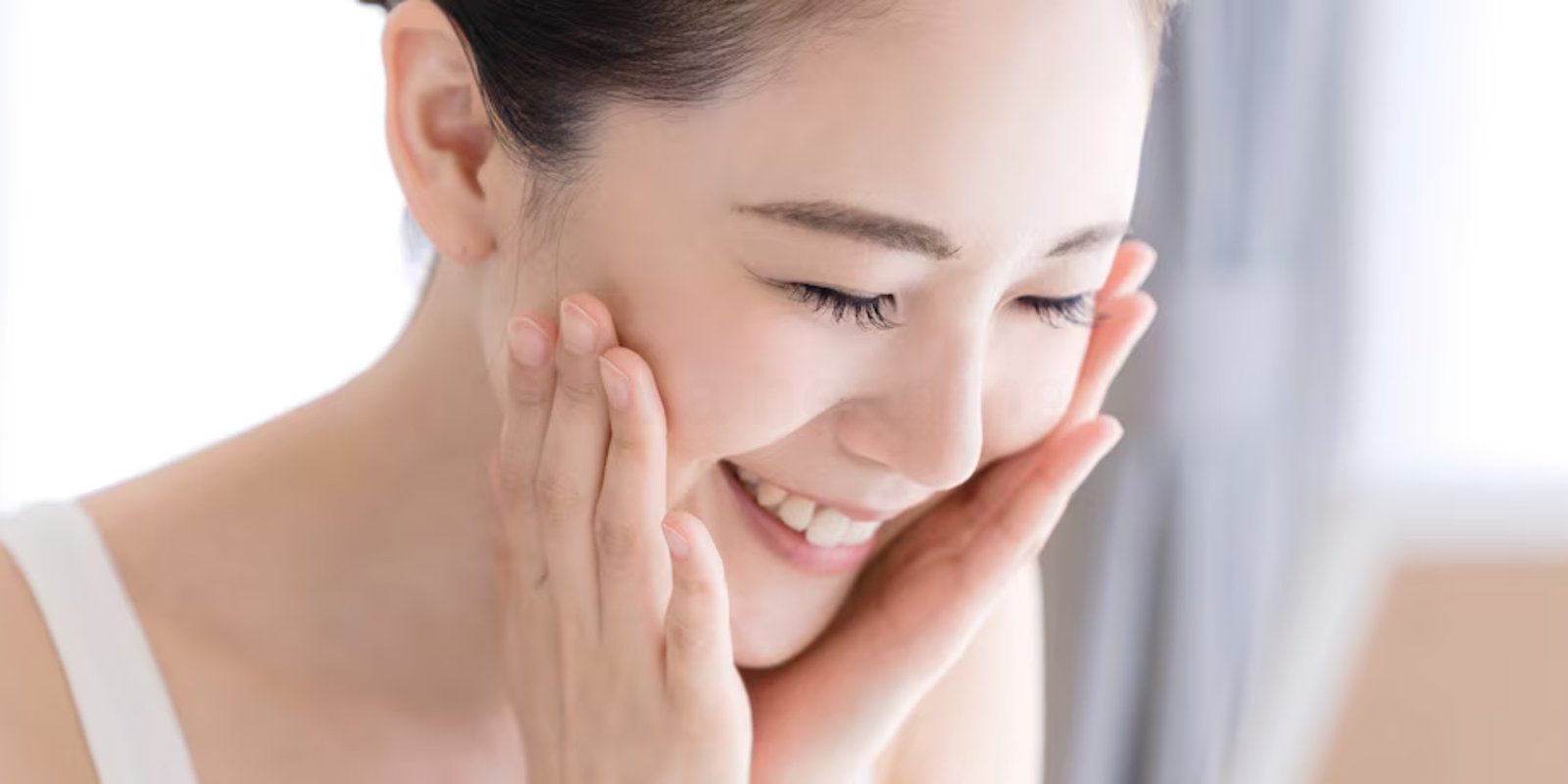 Smiling woman enjoying a face massage for clear, radiant skin