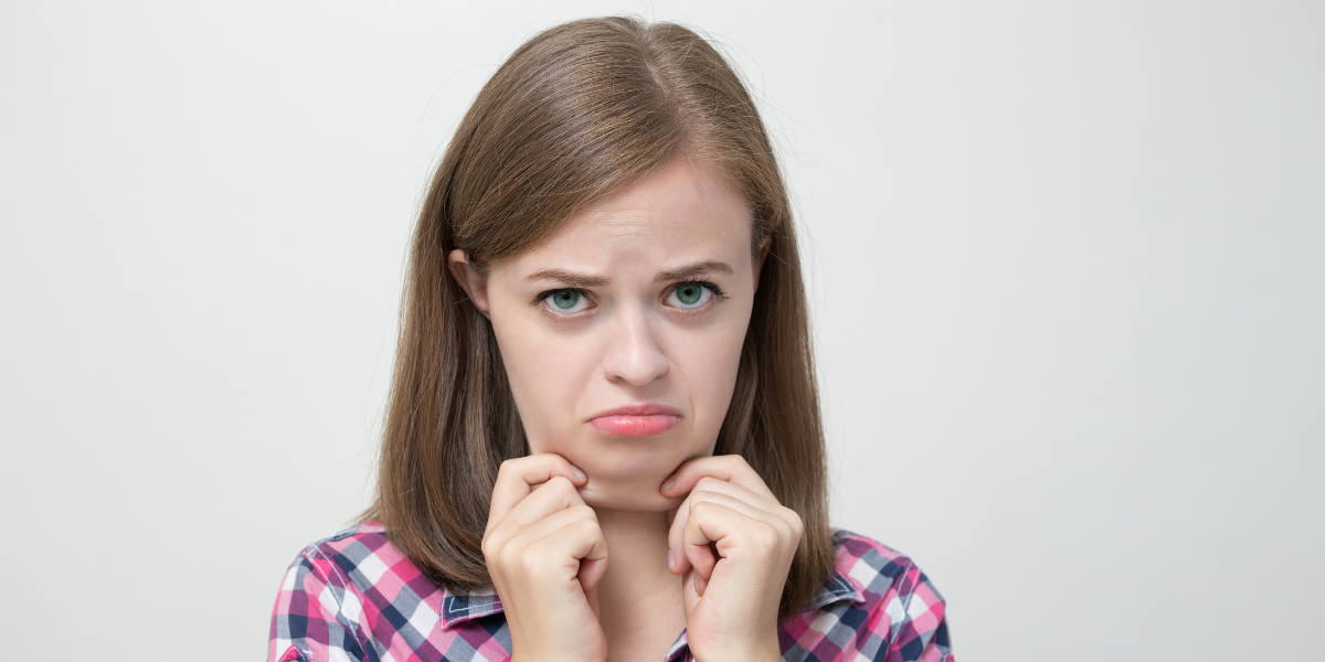 Woman with chubby face looking concerned about how to lose face fat